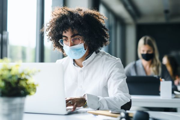 Workers in office wearing masks