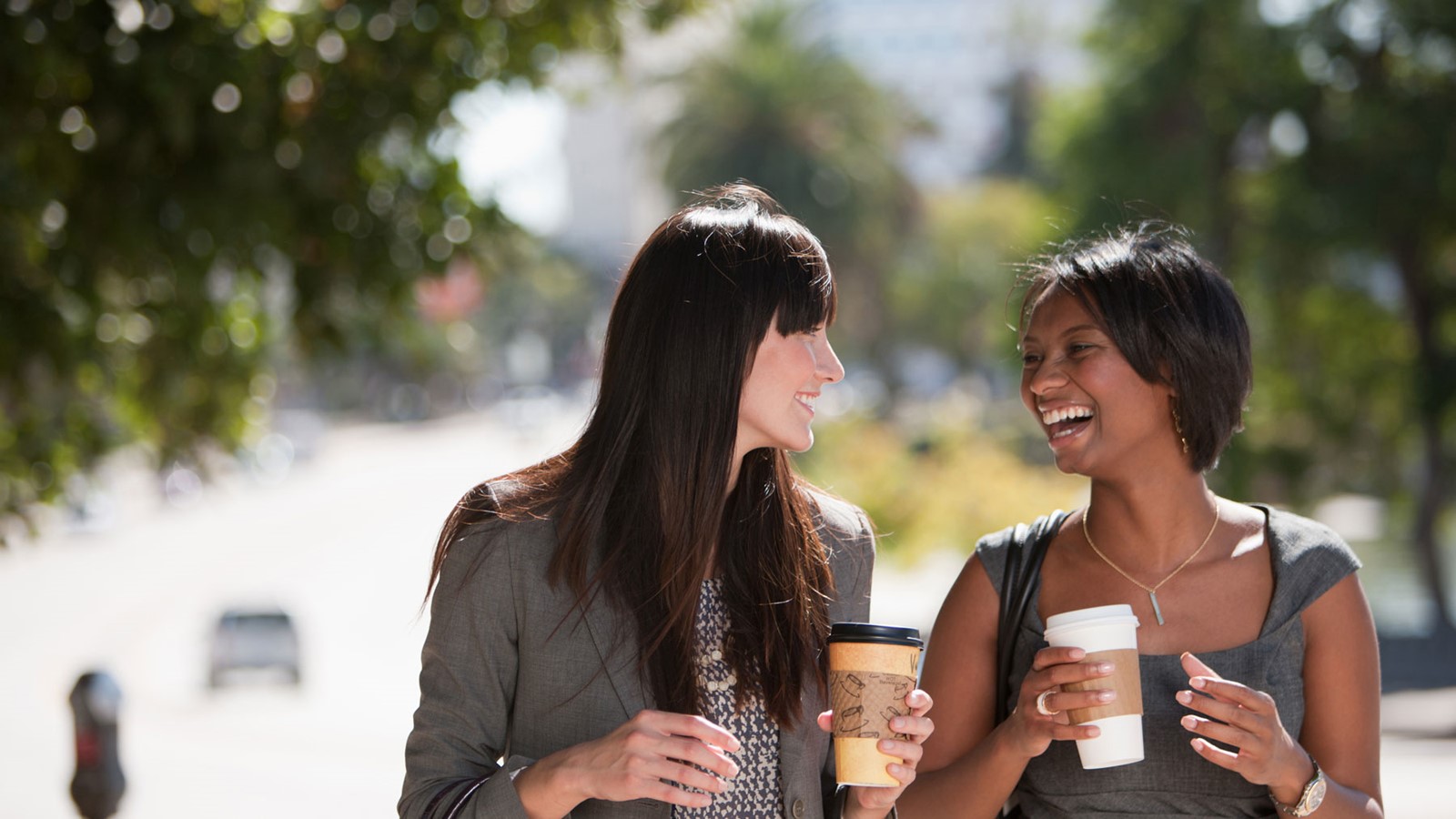 two-women-walking-enjoying-coffee-blog-banner