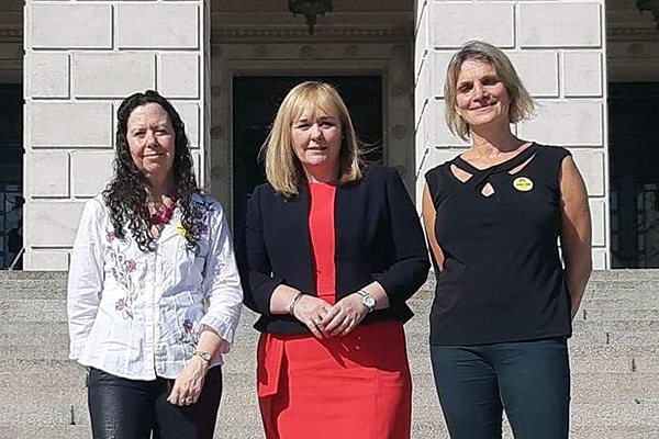 Left to right: Caryl Sibbett, vice chair of BAAT, Northern Ireland education minister Michelle McIlveen, and Jo Holmes, our Children, Young People and Families Lead